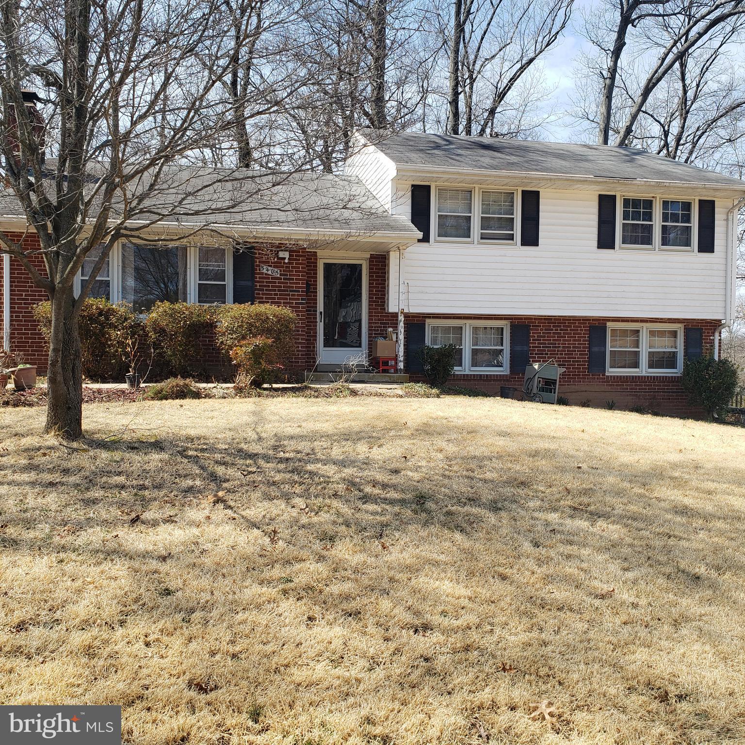 5405 Moultrie Road Springfield, VA 22151 - Photo 1 of 9 a front view of a house with a yard covered in snow