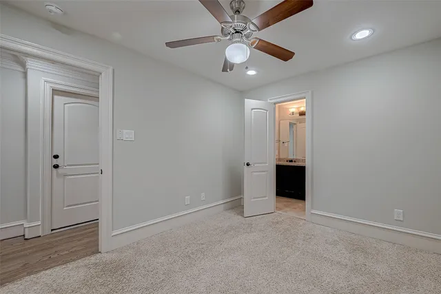 an empty room with closet and a ceiling fan