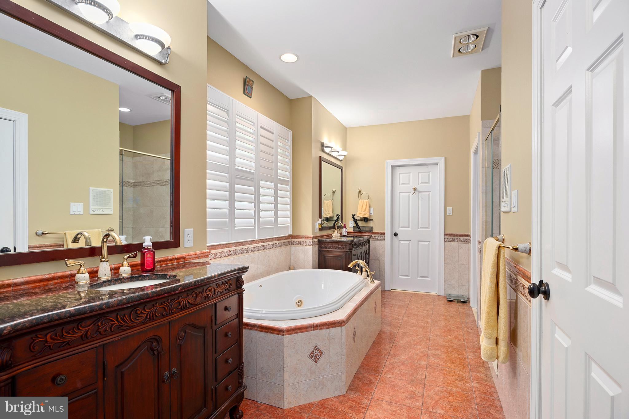 74 Lake Forest Drive Elkton, MD 21921 - Photo 29 of 65 a bathroom with a granite countertop double vanity sink a mirror and a bathtub