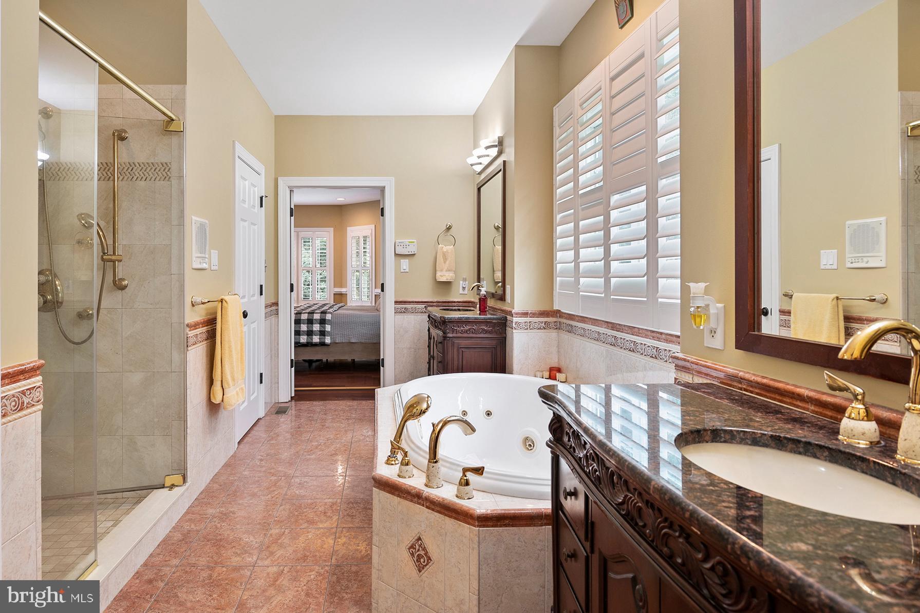 74 Lake Forest Drive Elkton, MD 21921 - Photo 30 of 65 a bathroom with a granite countertop tub sink and mirror