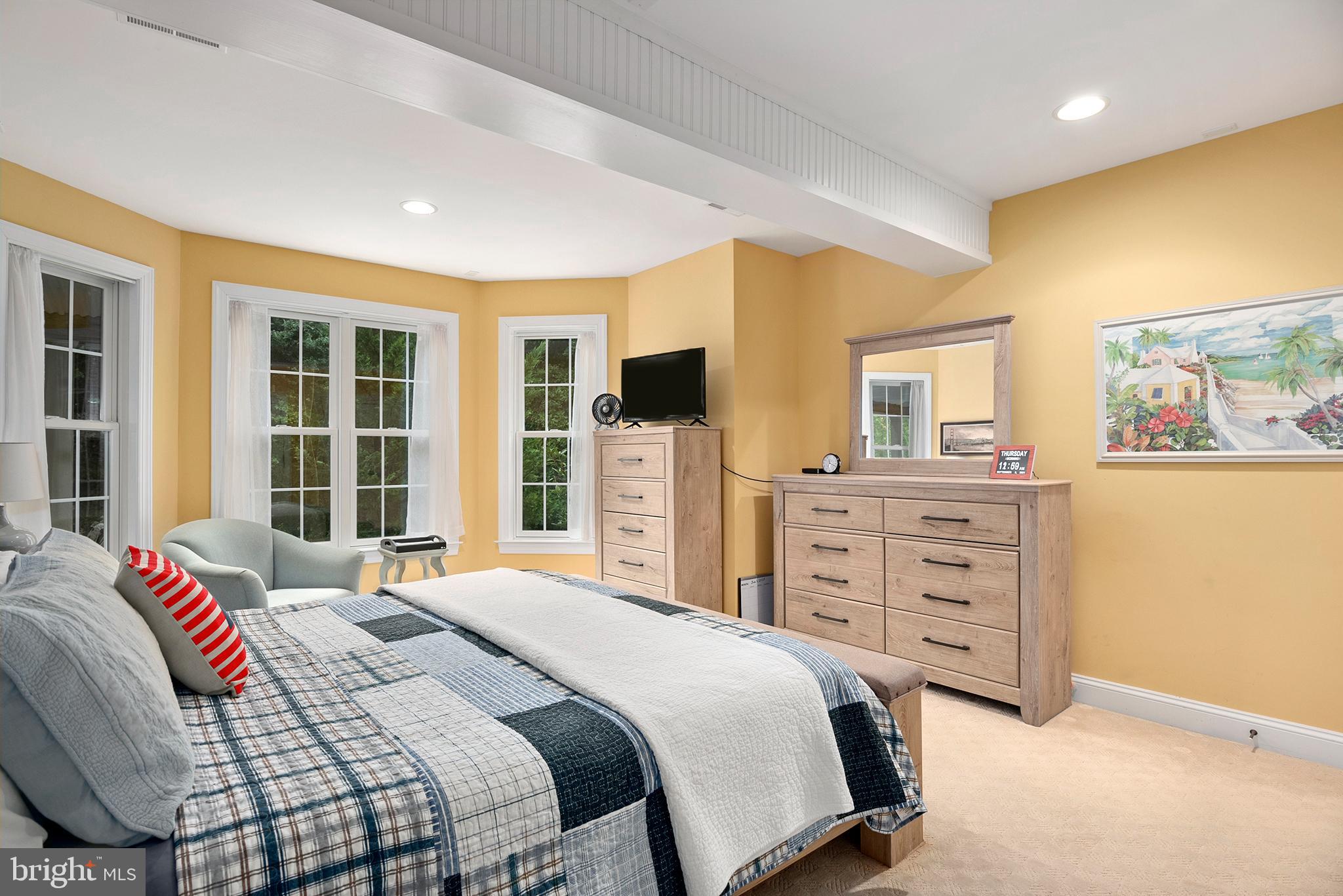 74 Lake Forest Drive Elkton, MD 21921 - Photo 56 of 65 a bedroom with a large bed and a flat tv screen on dresser