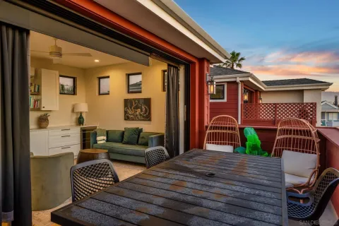 a living room with furniture a flat screen tv and a floor to ceiling window