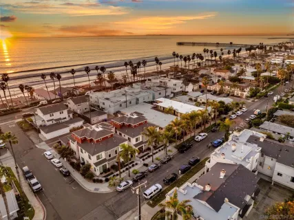 a dining room filled chandelier and wooden floor