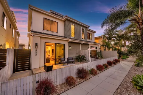 a front view of a house with a garden
