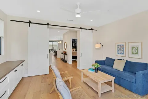 a bedroom with a bed and a view of kitchen