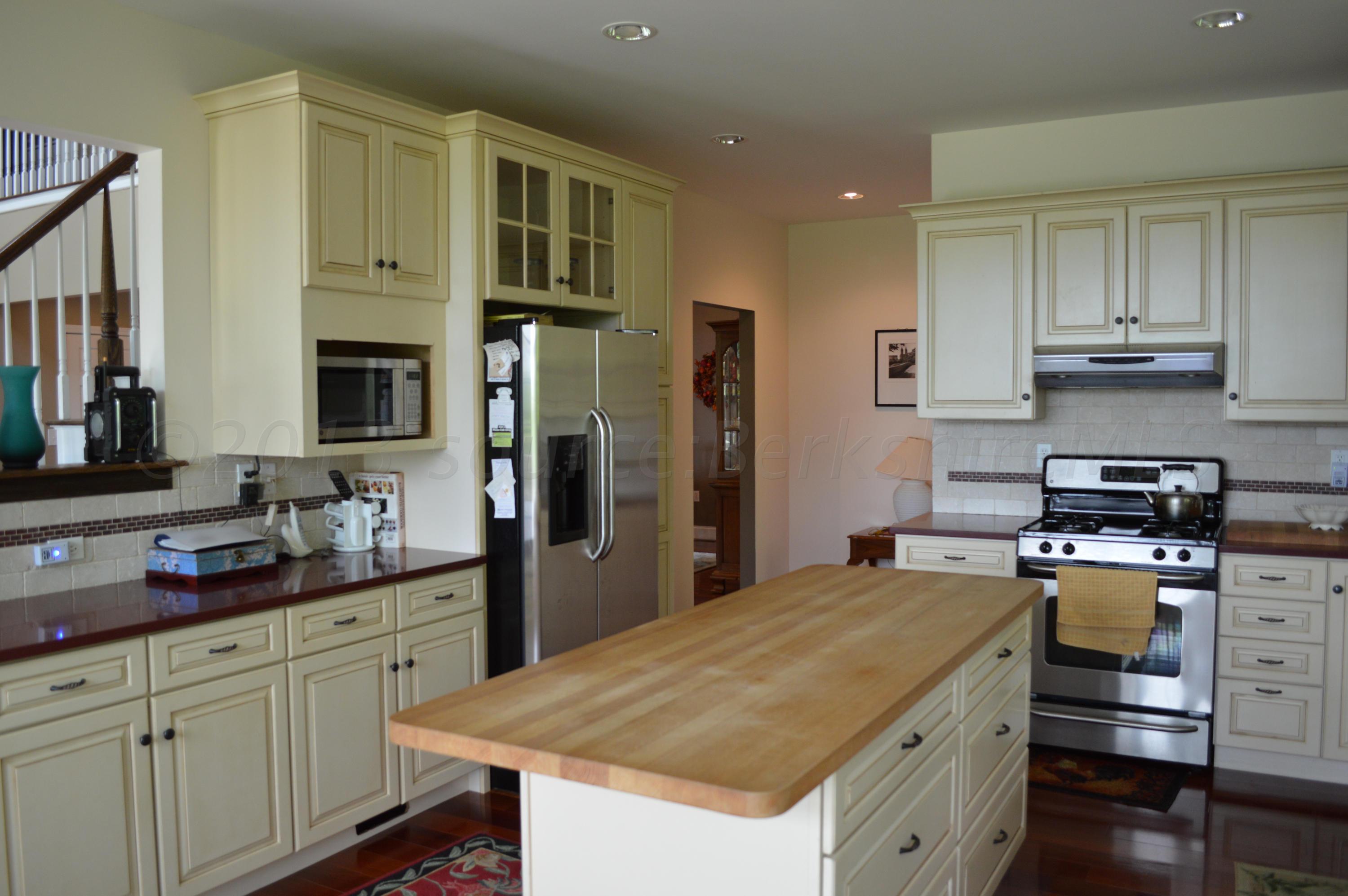 269 Skyline Ridge Road Becket, MA 01223 - Photo 13 of 42 a kitchen with stainless steel appliances a stove cabinets and wooden floor