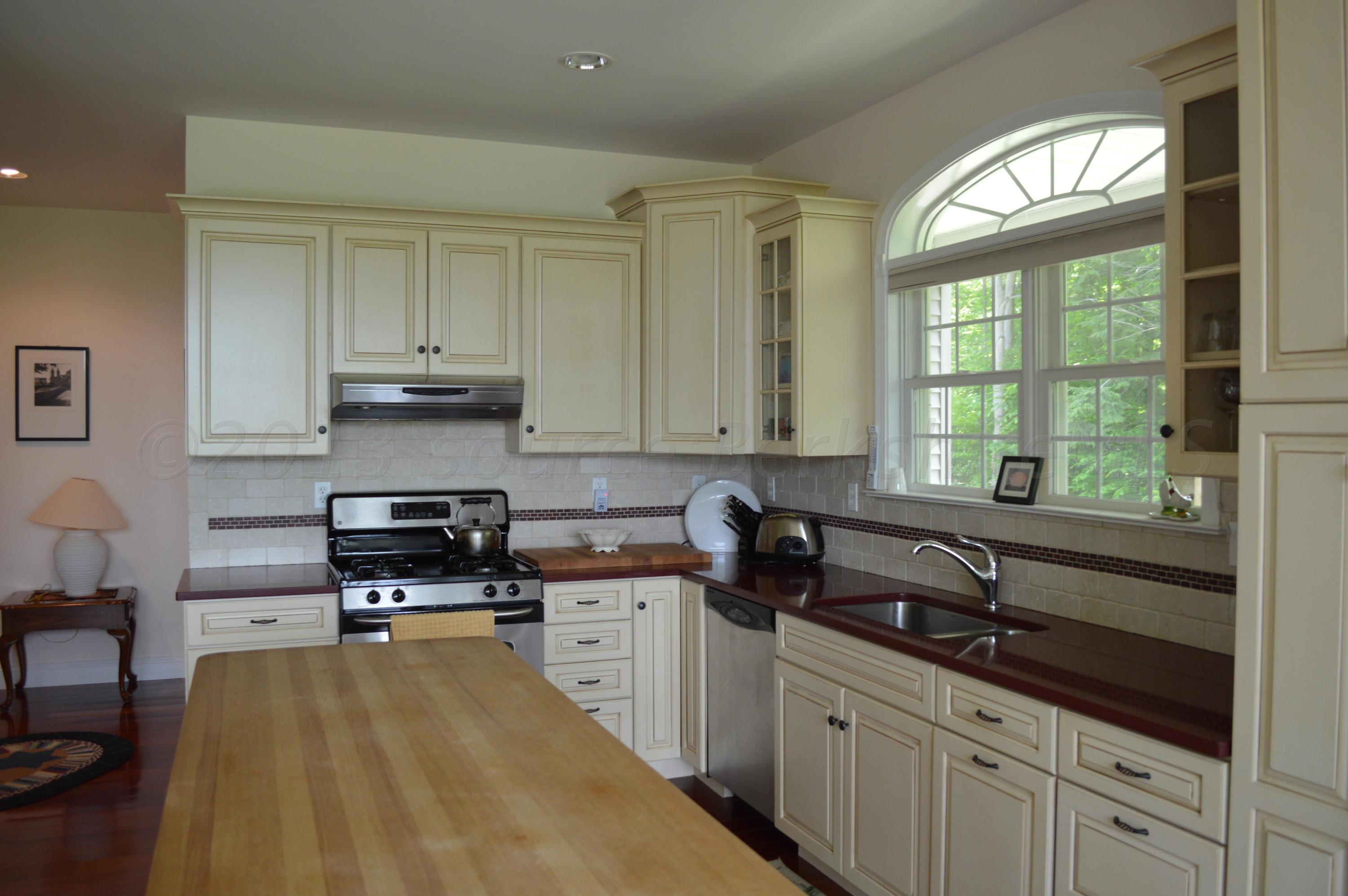 269 Skyline Ridge Road Becket, MA 01223 - Photo 15 of 42 a kitchen with stainless steel appliances a sink stove and cabinets