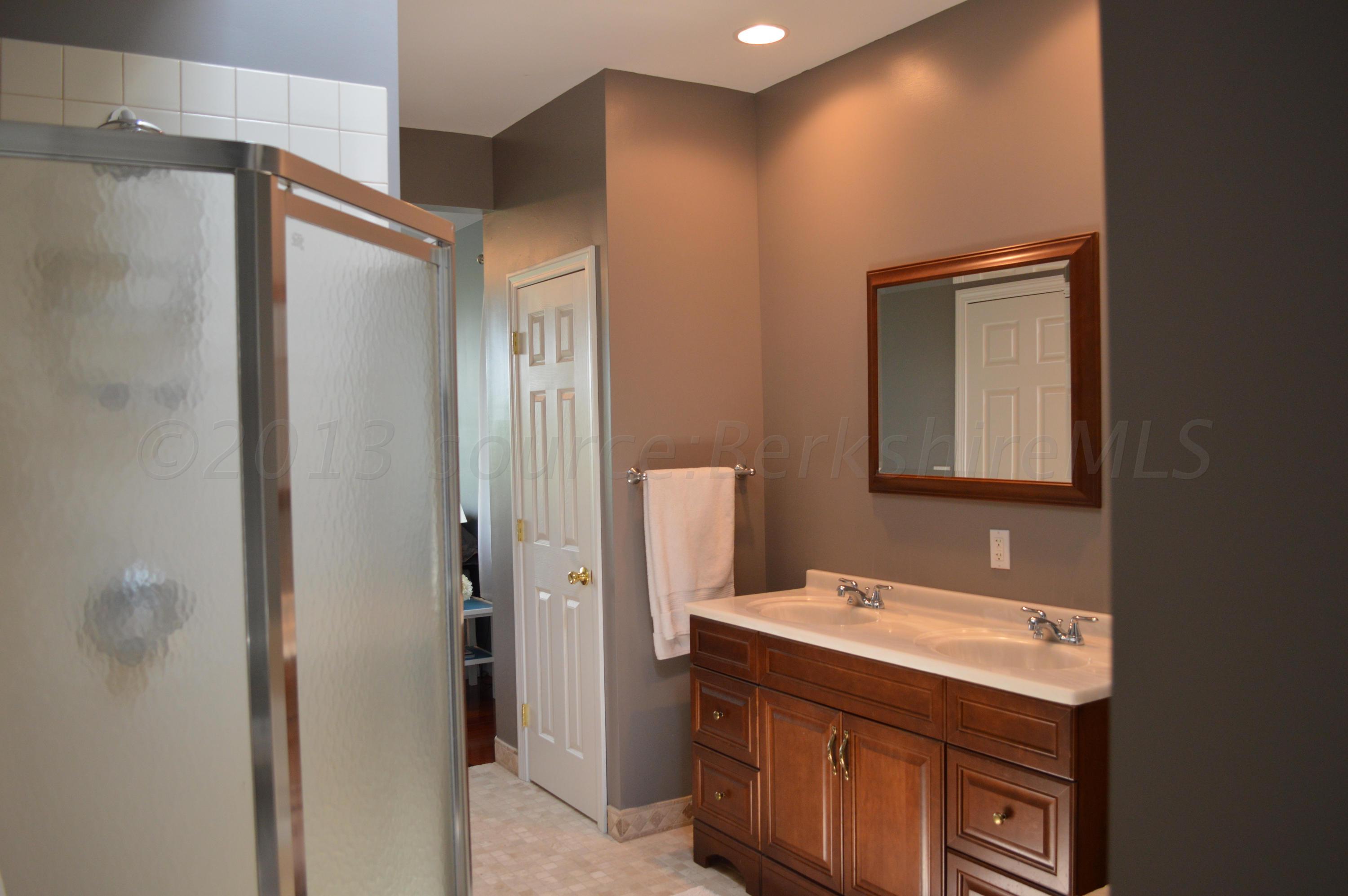 269 Skyline Ridge Road Becket, MA 01223 - Photo 20 of 42 a bathroom with a sink vanity and a mirror