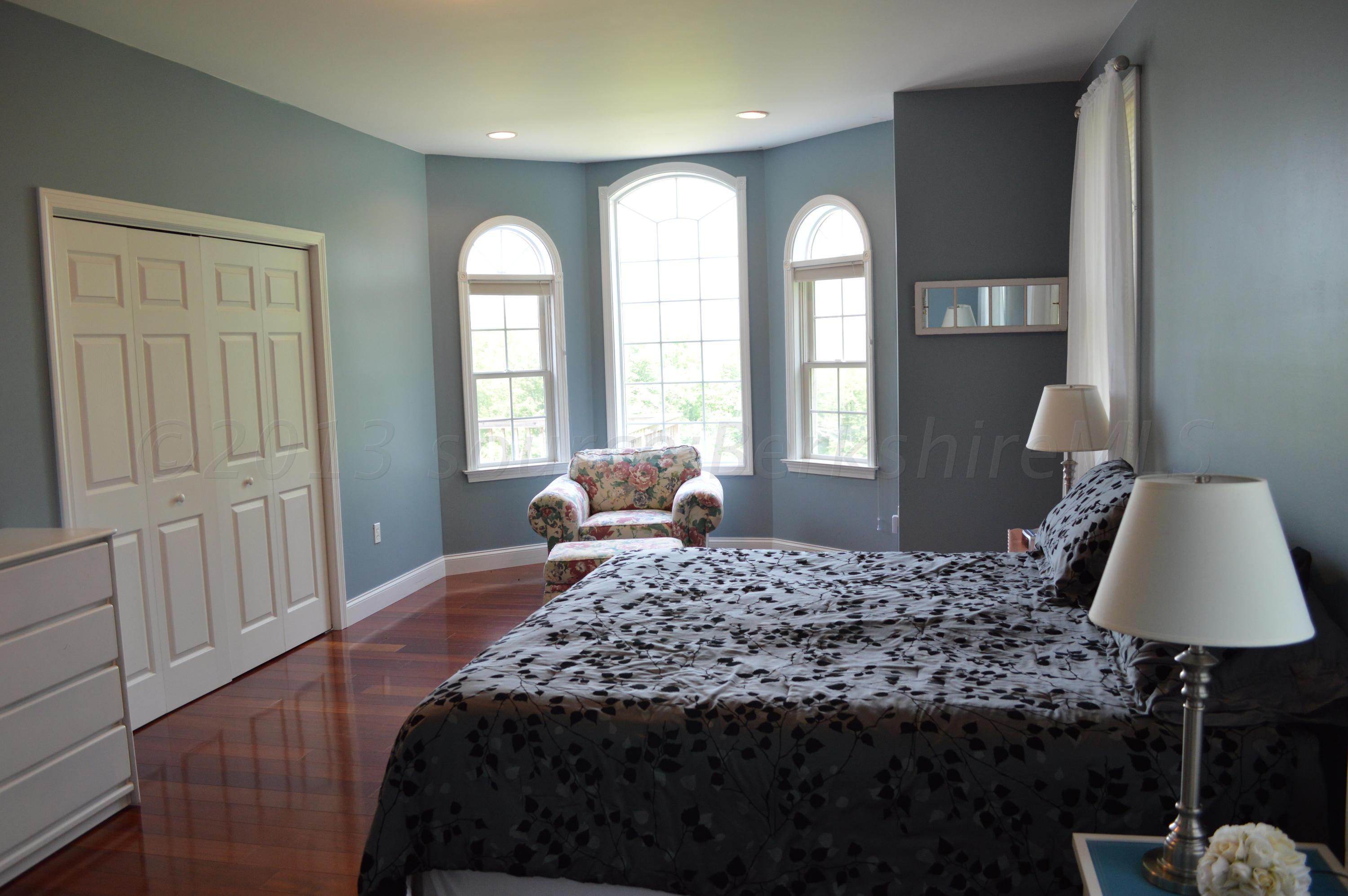 269 Skyline Ridge Road Becket, MA 01223 - Photo 21 of 42 a bedroom with a bed window and wall painting
