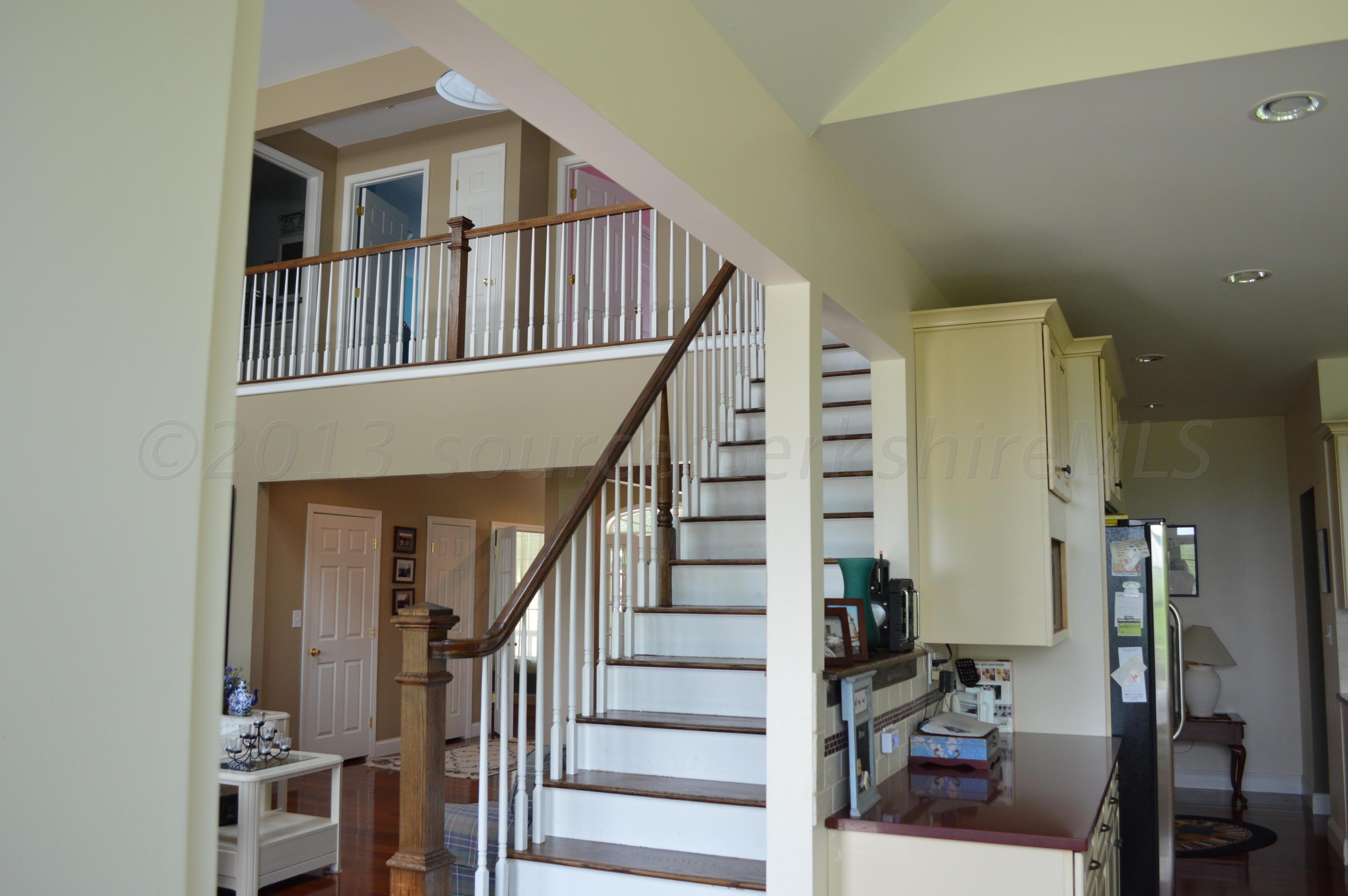 269 Skyline Ridge Road Becket, MA 01223 - Photo 24 of 42 a view of staircase with lots of frames and a rug