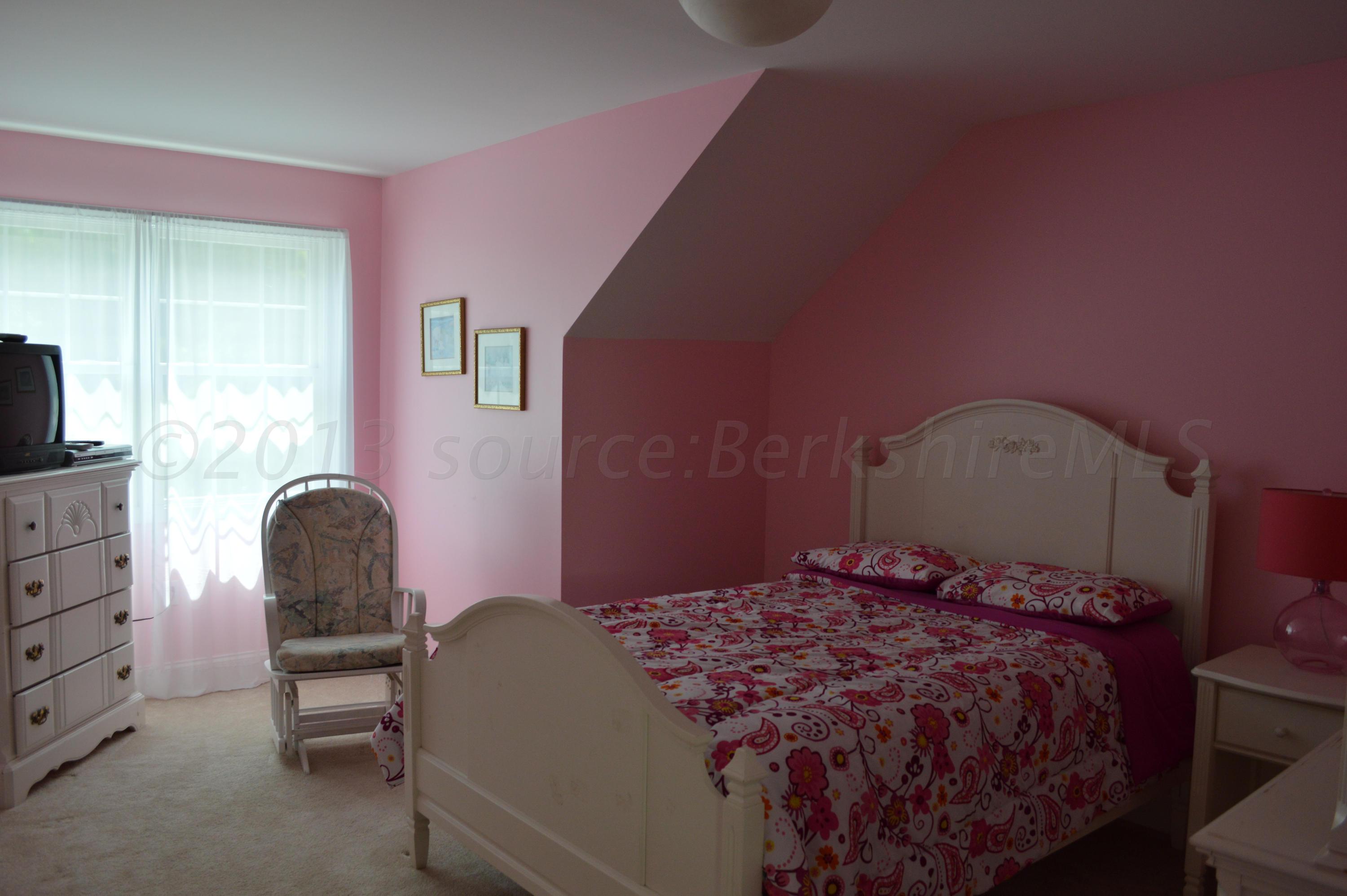 269 Skyline Ridge Road Becket, MA 01223 - Photo 25 of 42 a bedroom with a bed and a chair