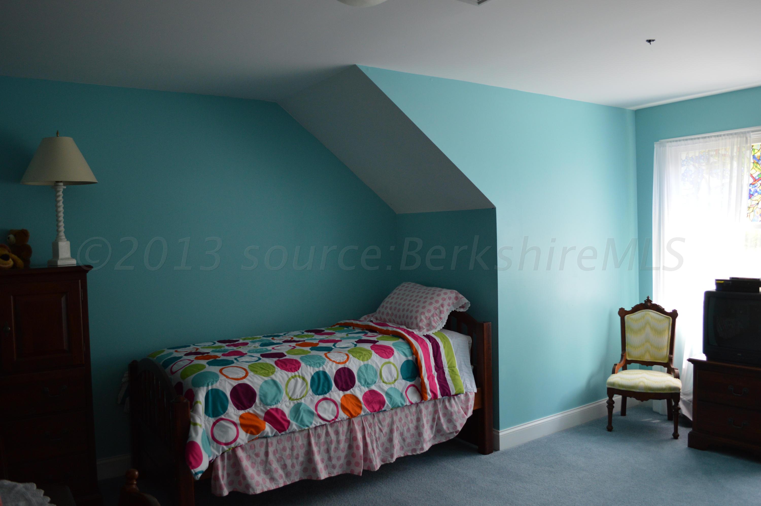 269 Skyline Ridge Road Becket, MA 01223 - Photo 27 of 42 a bedroom with a bed and a chair