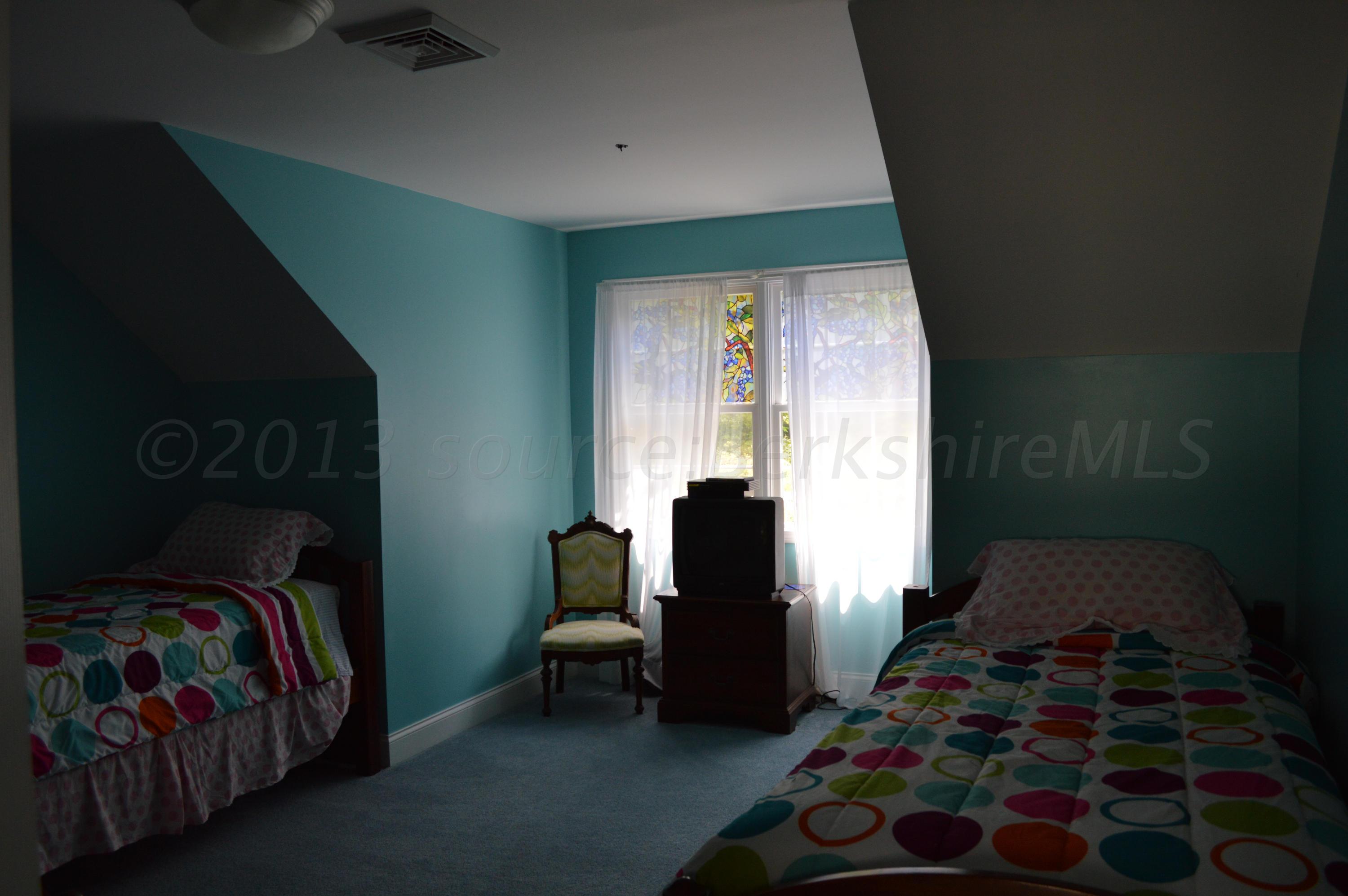 269 Skyline Ridge Road Becket, MA 01223 - Photo 29 of 42 a bedroom with a bed and a window