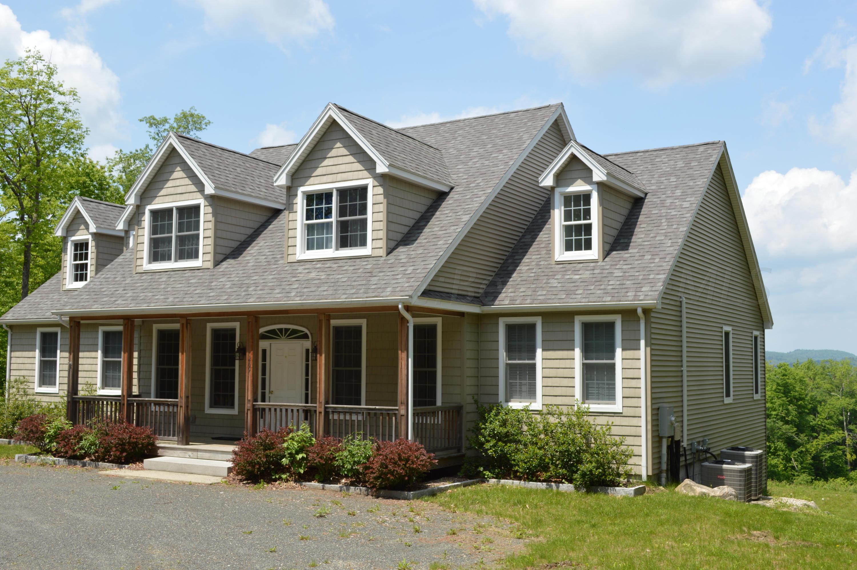 269 Skyline Ridge Road Becket, MA 01223 - Photo 32 of 42 a front view of a house with yard and green space