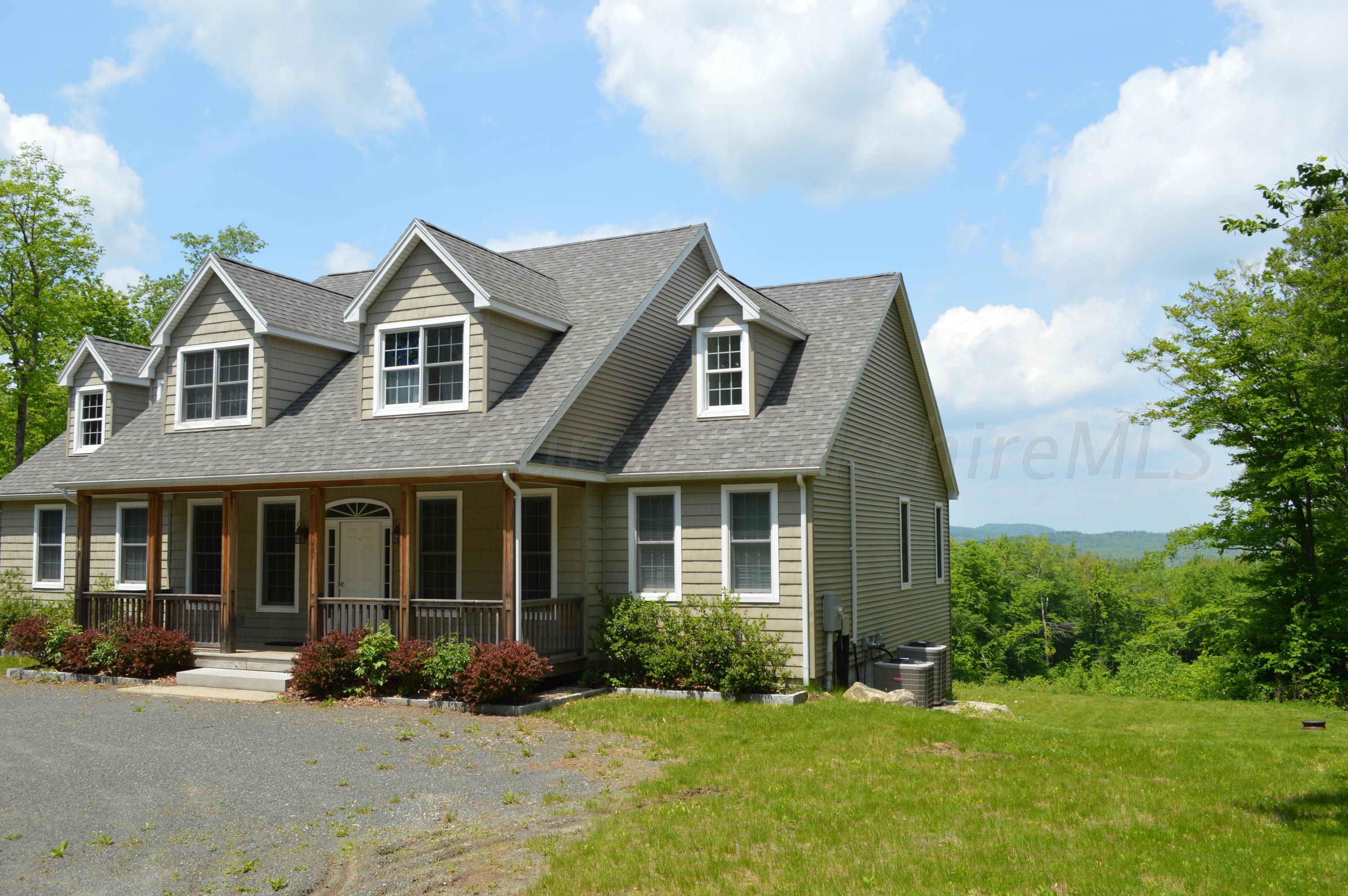 269 Skyline Ridge Road Becket, MA 01223 - Photo 33 of 42 a front view of a house with a yard