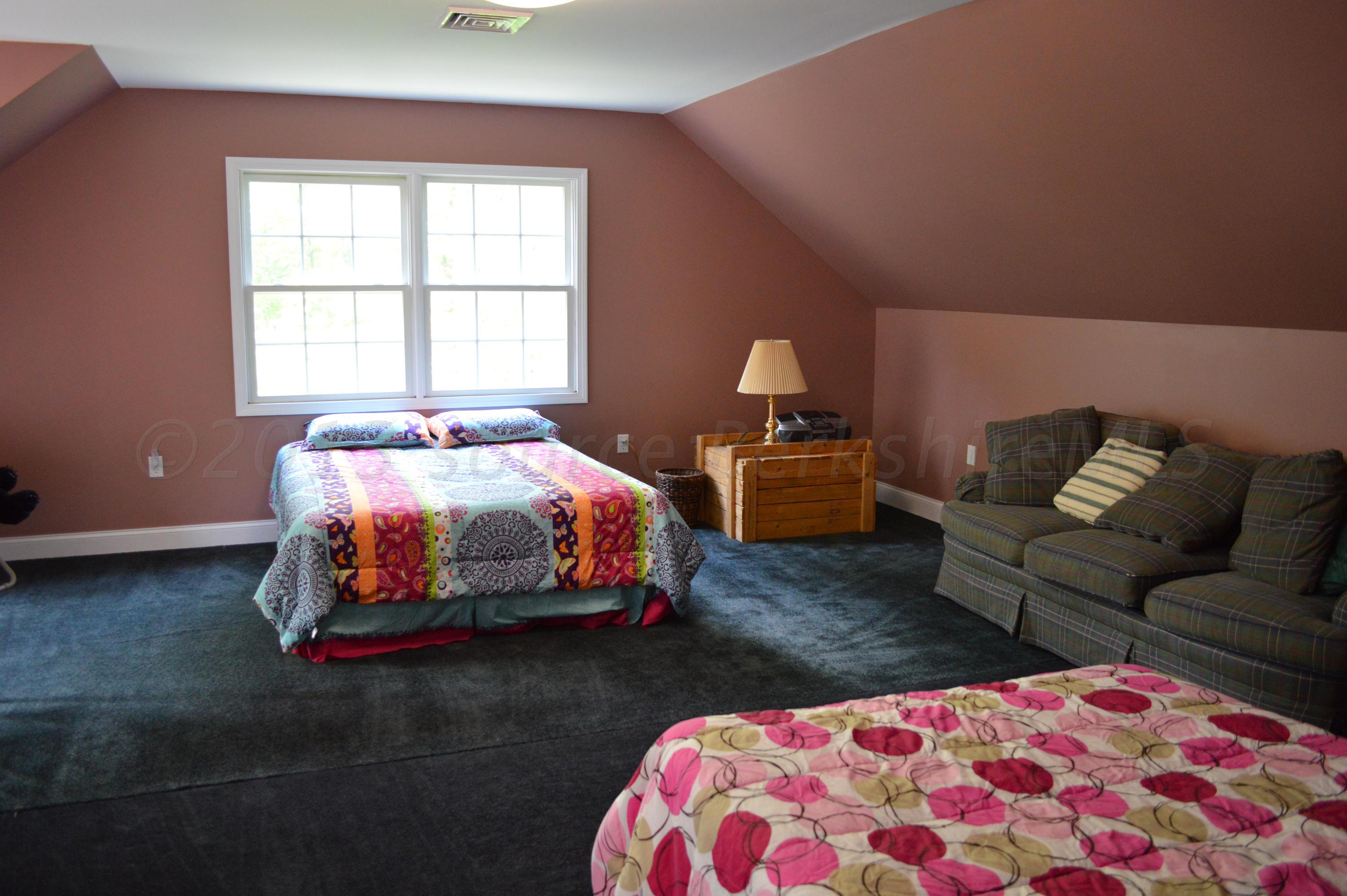 269 Skyline Ridge Road Becket, MA 01223 - Photo 38 of 42 a bedroom with a bed and a couch