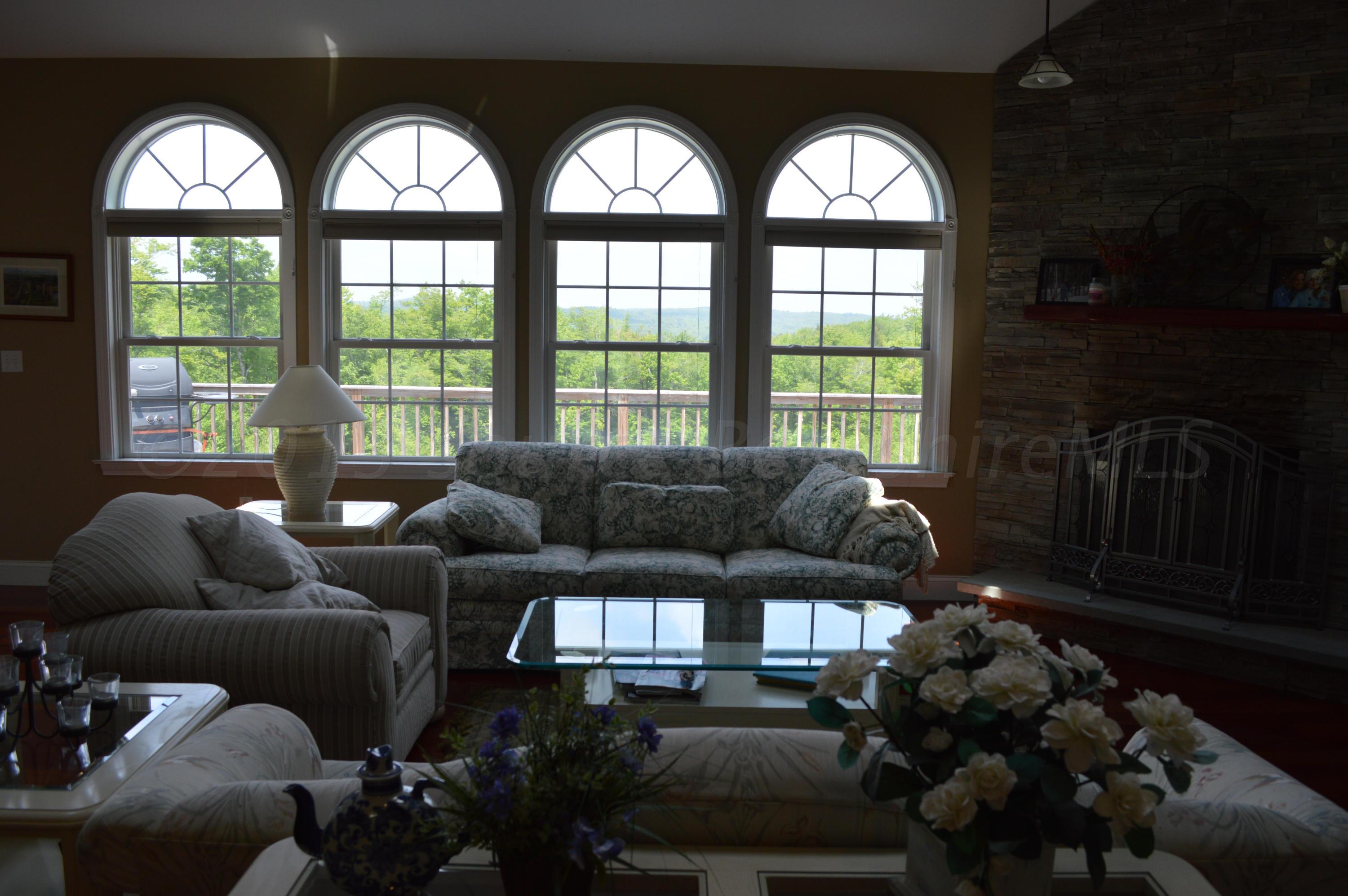 269 Skyline Ridge Road Becket, MA 01223 - Photo 8 of 42 a living room with furniture and a large window
