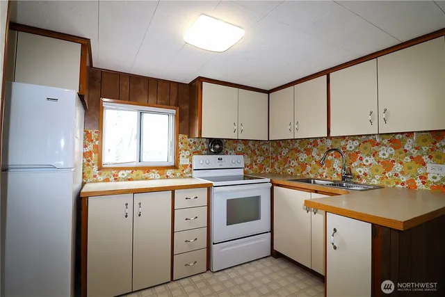 a kitchen with white cabinets sink and white appliances