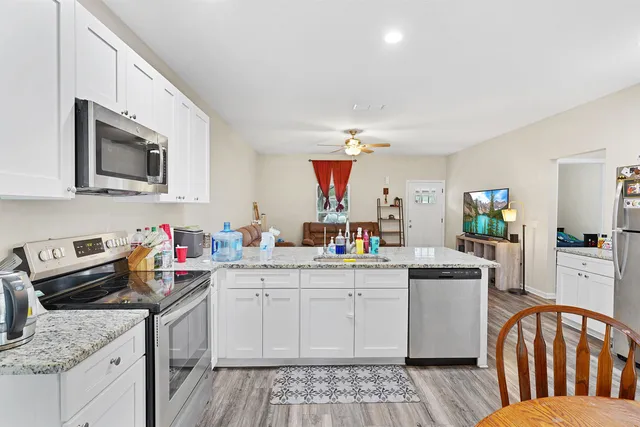 a kitchen that has a sink and a stove top oven