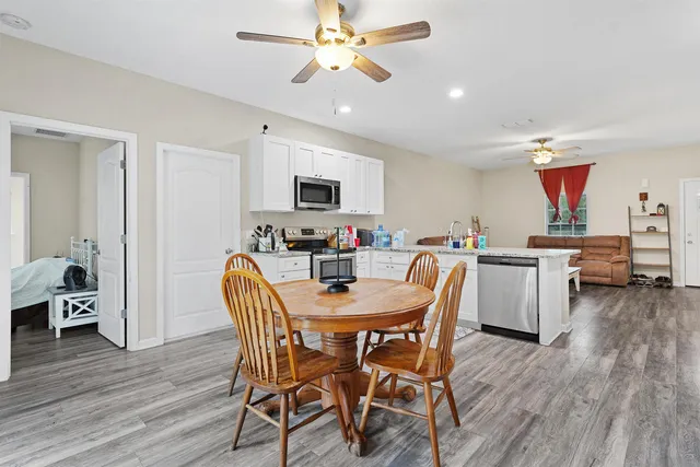 a dining room with furniture and wooden floor