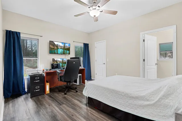 a bedroom with a bed and a desk