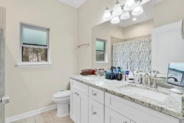 a bathroom with a sink a vanity and a large mirror