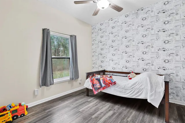 a bedroom with a bed and a window