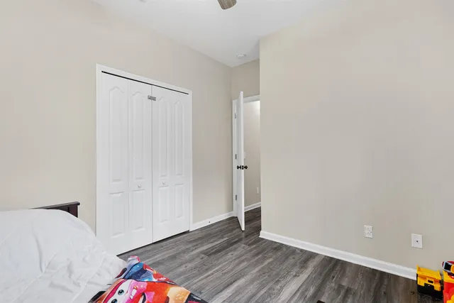a view of bedroom with furniture and wooden floor