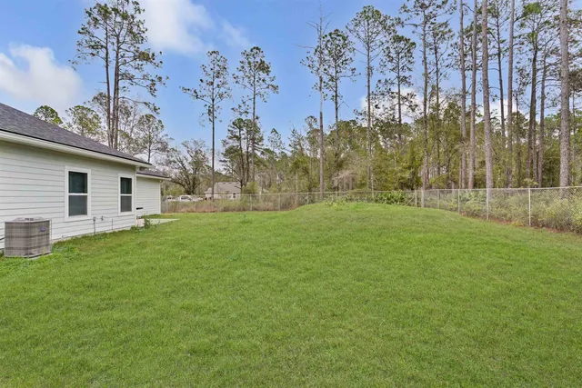 a view of a backyard with large trees