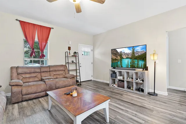a living room with furniture and wooden floor