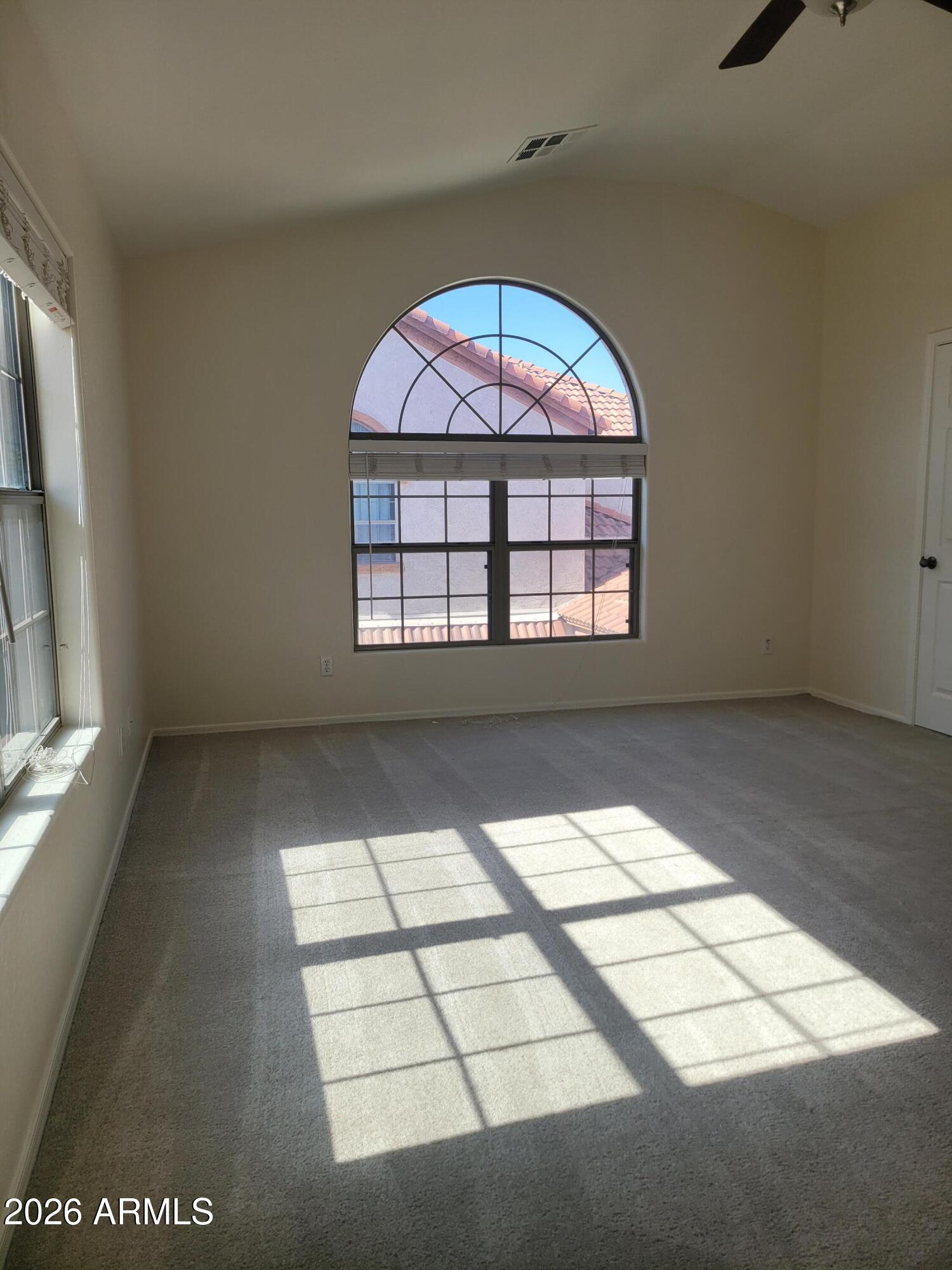 1453 South Sinova Avenue Gilbert, AZ 85296 - Photo 36 of 46 an empty room with windows and view of kitchen