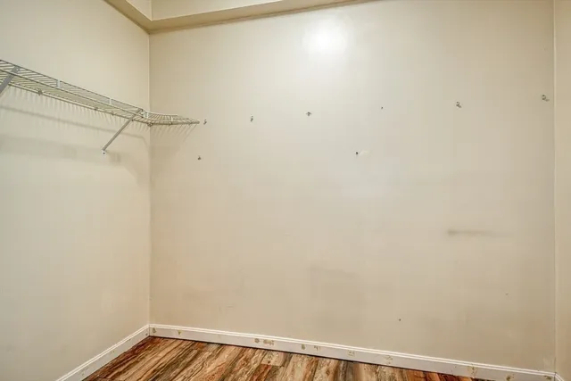 an empty room with a chandelier fan