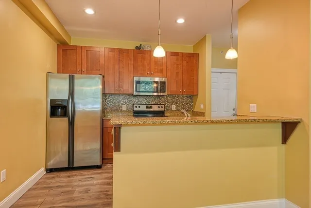 a kitchen with stainless steel appliances a refrigerator and a stove