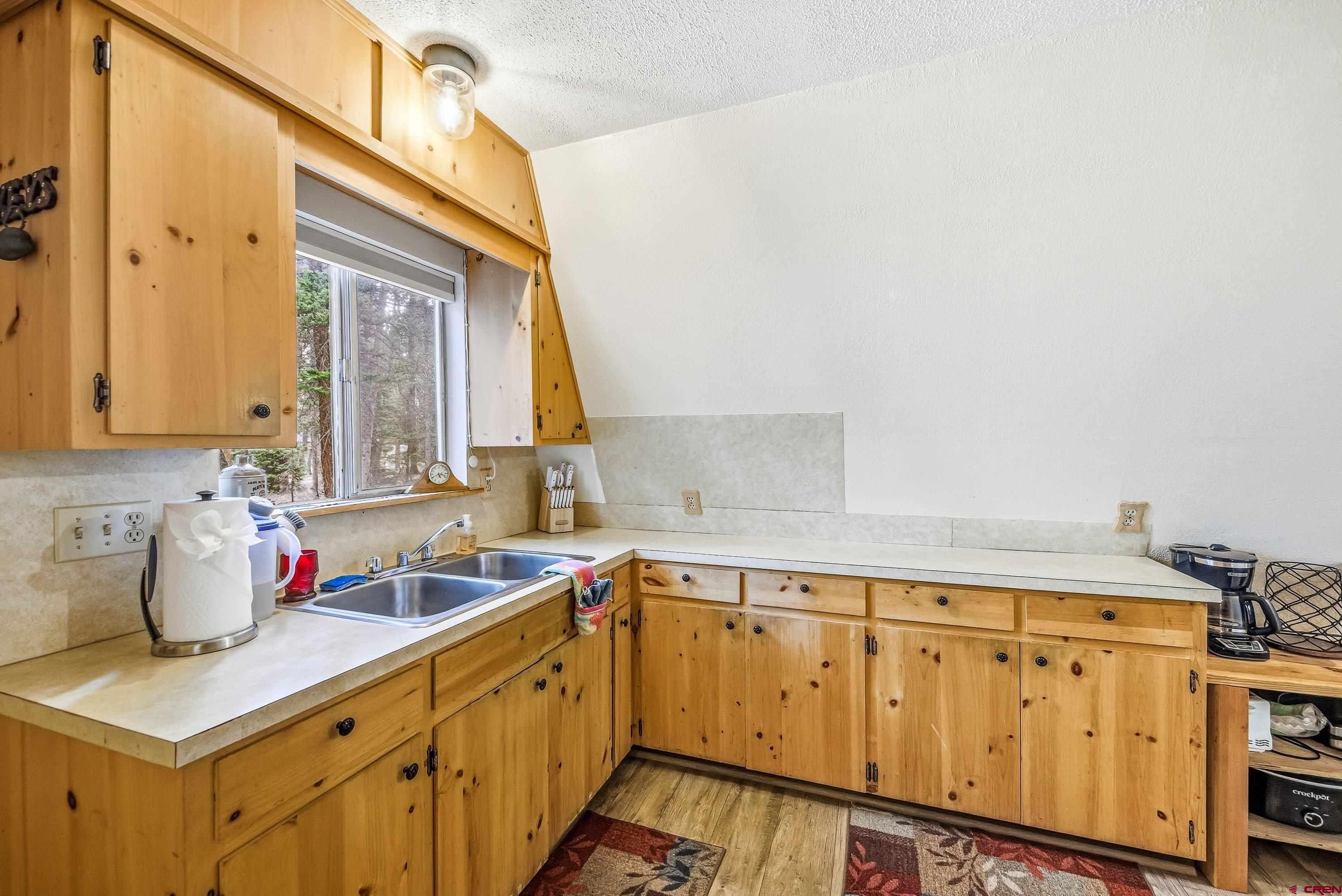 125 Aspen Trail Cimarron, CO 81220 - Photo 12 of 37 a kitchen with stainless steel appliances a sink stove and cabinets