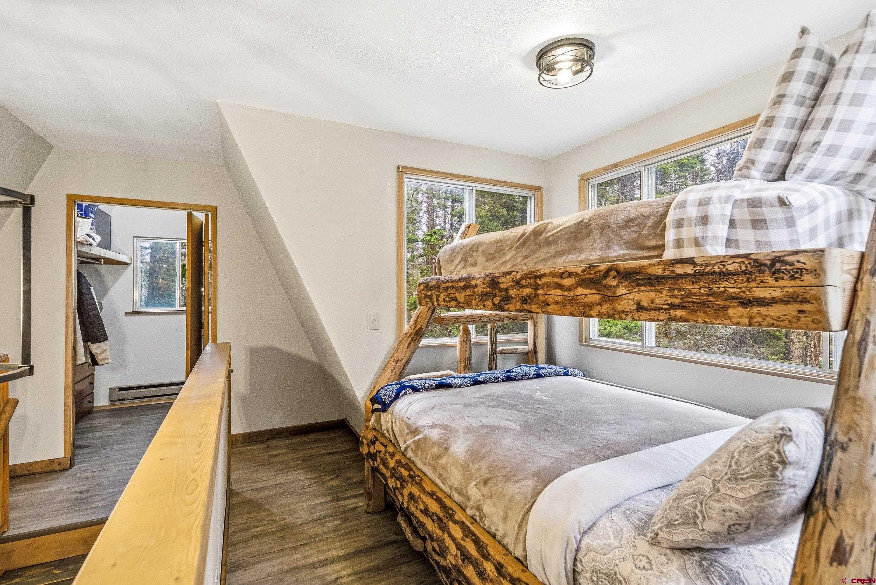 125 Aspen Trail Cimarron, CO 81220 - Photo 18 of 37 a bedroom with a bed and wooden floor