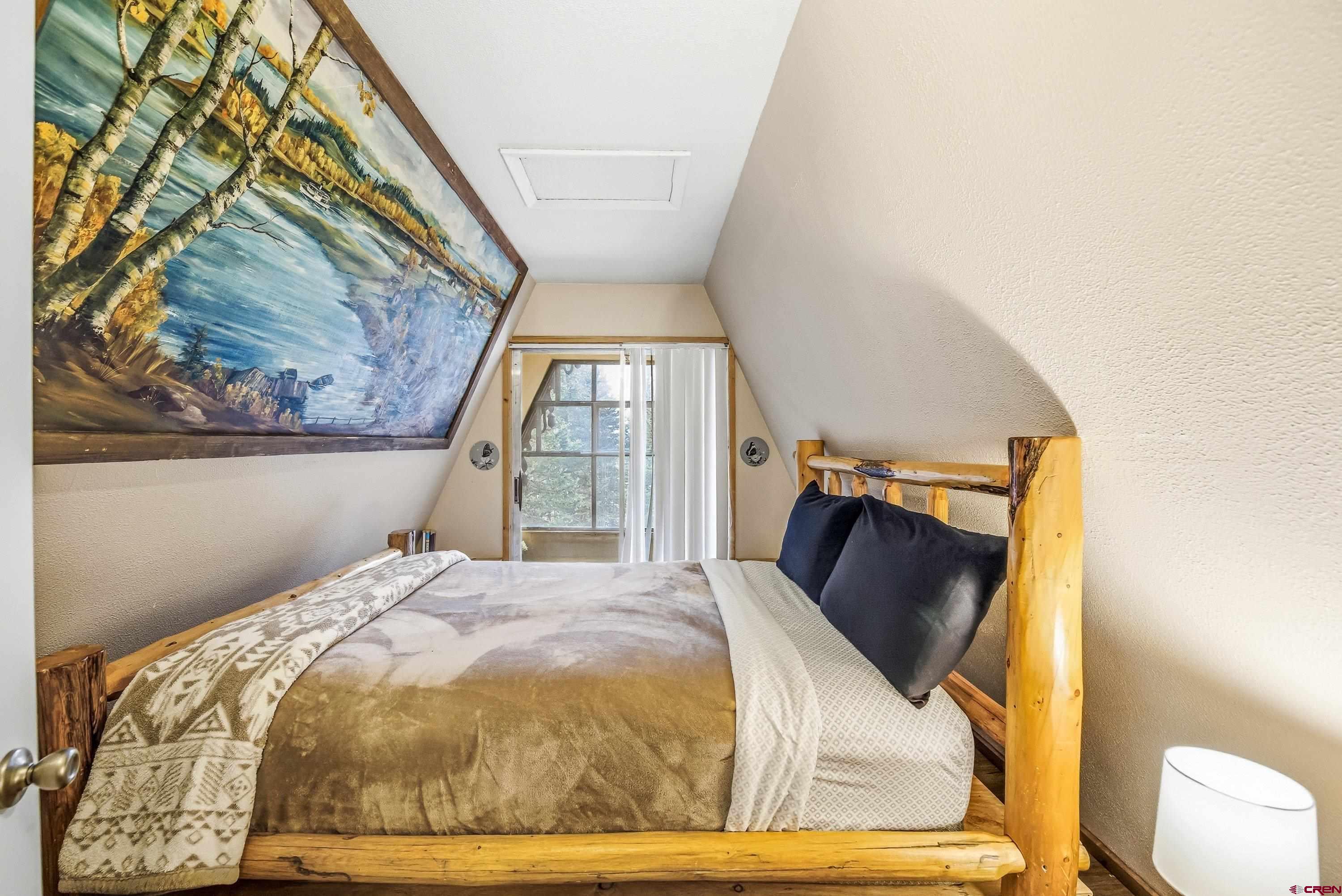 125 Aspen Trail Cimarron, CO 81220 - Photo 22 of 37 a bedroom with a bed and a painting on the wall