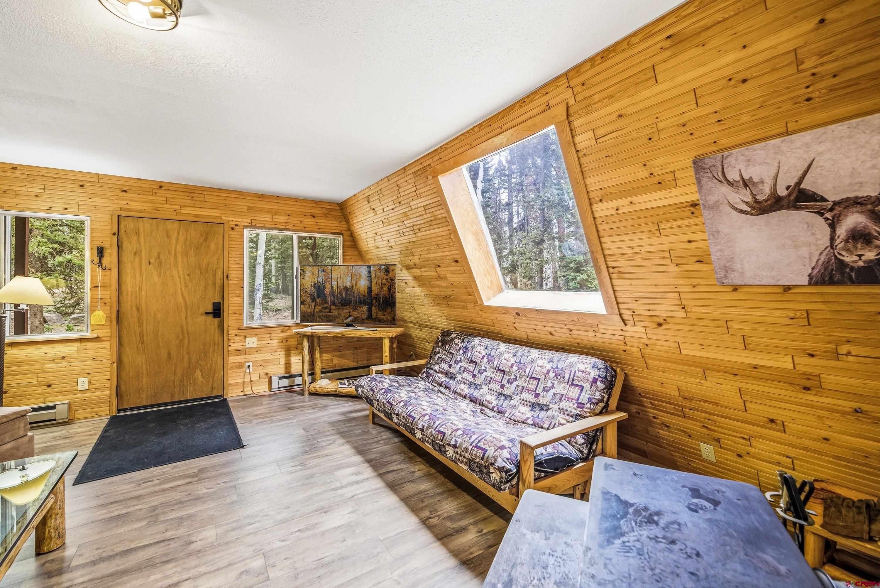 125 Aspen Trail Cimarron, CO 81220 - Photo 5 of 37 a bedroom with a bed and wooden floor