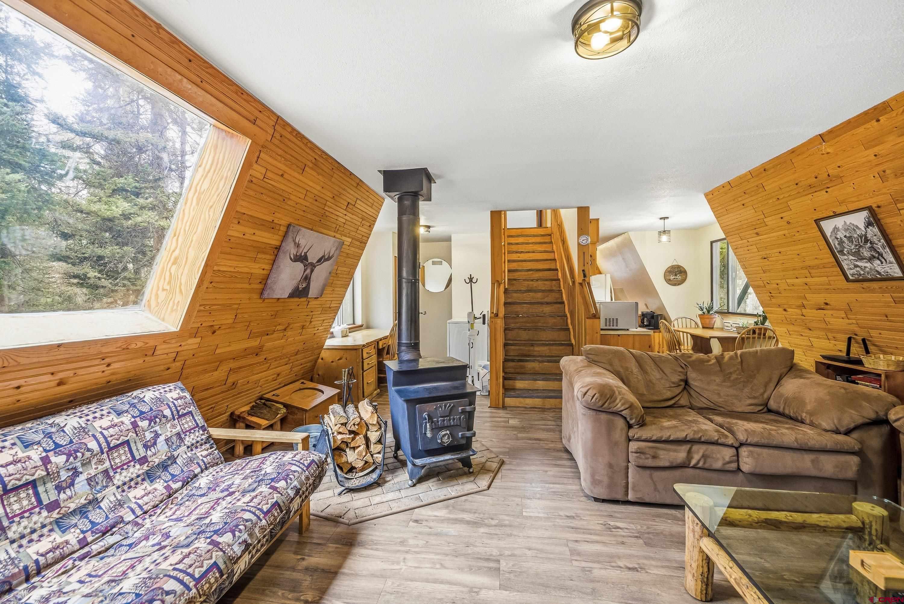 125 Aspen Trail Cimarron, CO 81220 - Photo 7 of 37 a living room with furniture and a floor to ceiling window