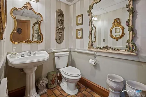 a bathroom with a double vanity sink toilet and shower