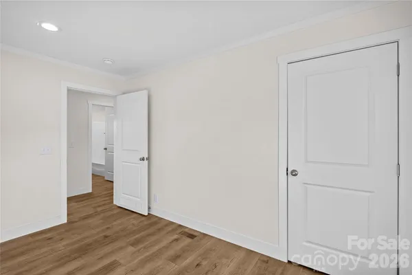 a view of an empty room and wooden floor