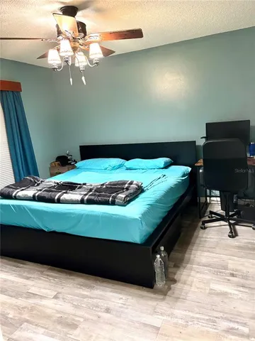 a bed sitting in a bedroom next to a window