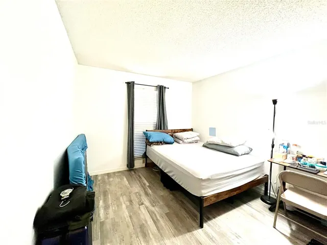 a bed room with a bed and a chair