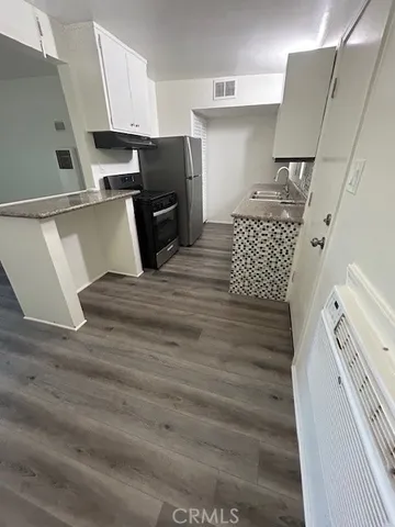 a kitchen with a sink and refrigerator