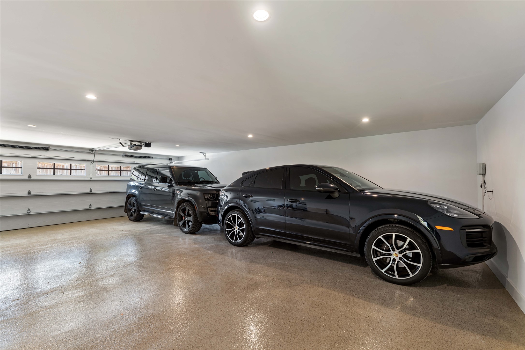 814 Azalea Street Houston, TX 77018 - Photo 26 of 31 Oversized four-car garage featuring epoxy flooring and extra space for storage or workspace.