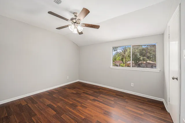 a view of a room with wooden floor and window