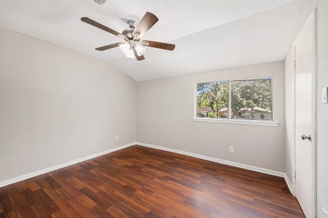 wooden floor in an empty room with a window