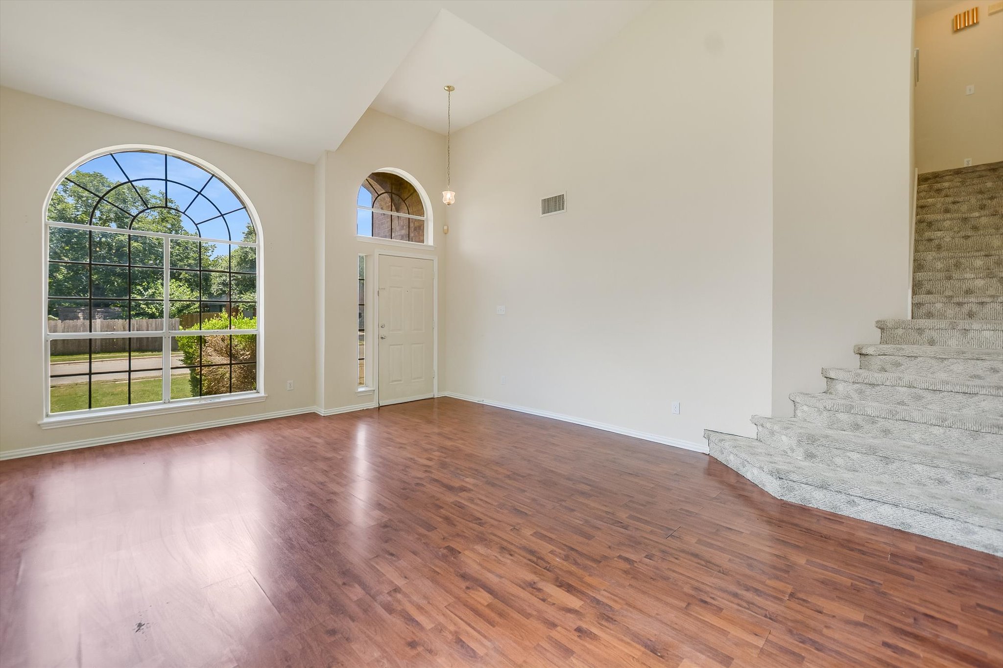 1008 Double File Trail Round Rock, TX 78665 - Photo 3 of 20 Voluminous ceilings elevate this naturally illuminated living area with inviting wood flooring.
