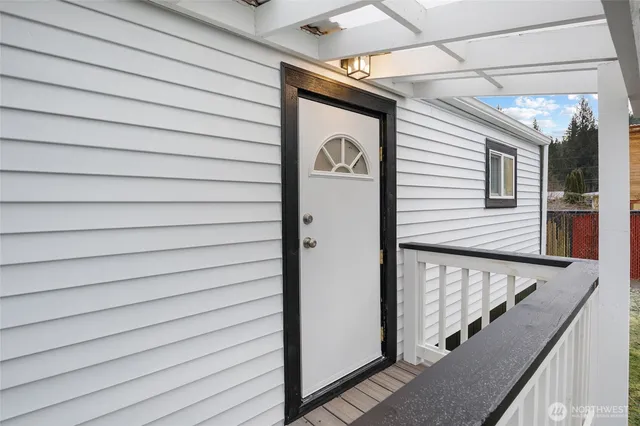 a view of a house with wooden deck