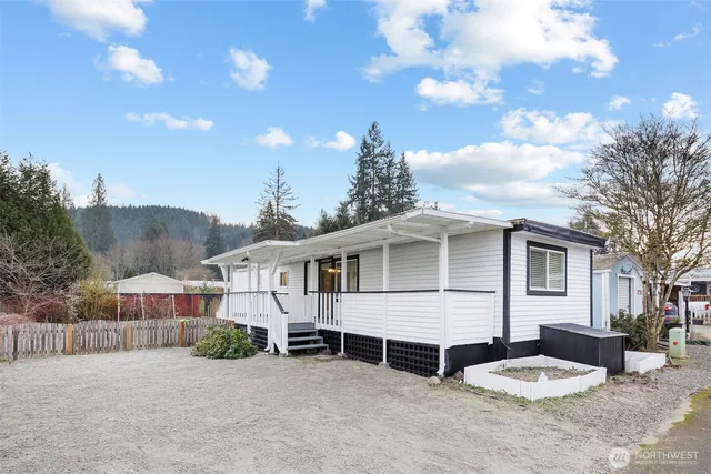 a white house with tree in the background