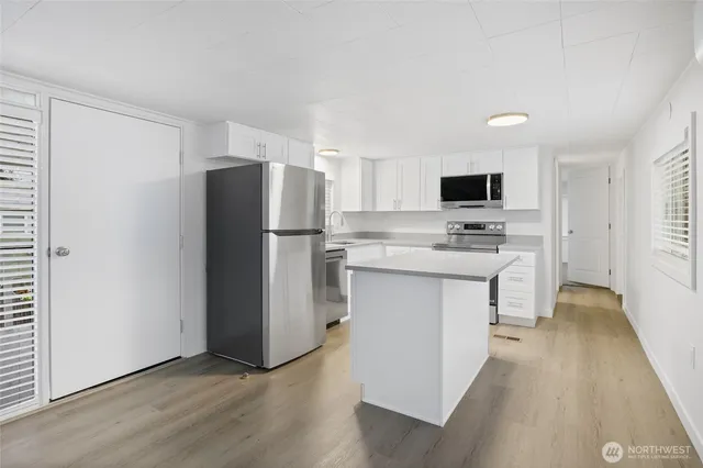 a kitchen with stainless steel appliances a refrigerator stove microwave and sink